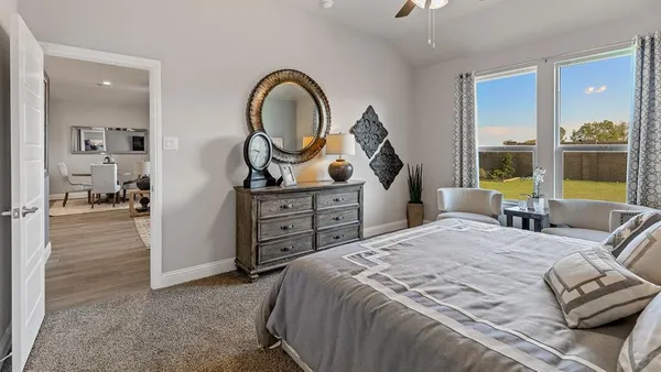 a bedroom with a bed and a dresser