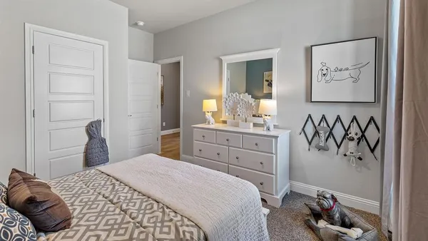 a bedroom with a bed and cupboard