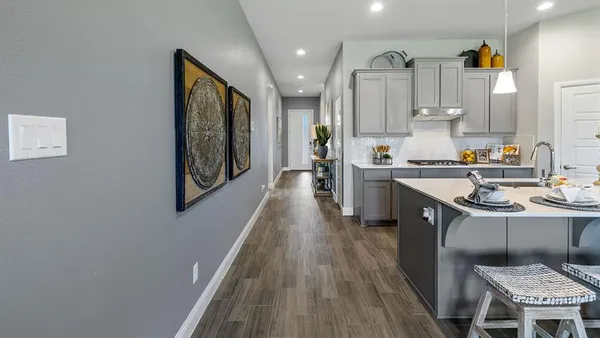 a kitchen with stainless steel appliances granite countertop a sink stove and wooden floor