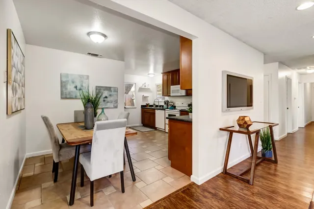 a view of a dining room with furniture and wooden floor