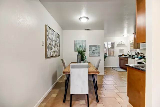 a dining room with furniture and wooden floor
