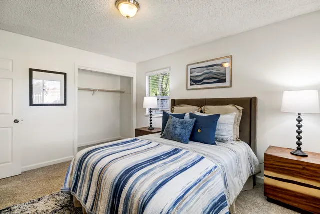 a bedroom with bed and night stand