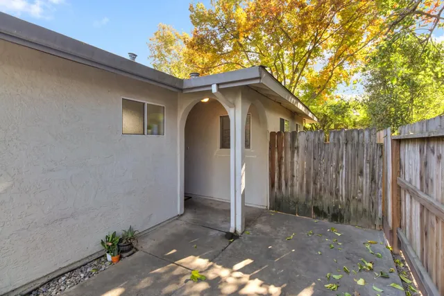 a backyard of a house with a tree