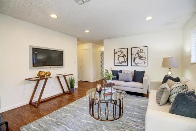 a living room with furniture and a flat screen tv