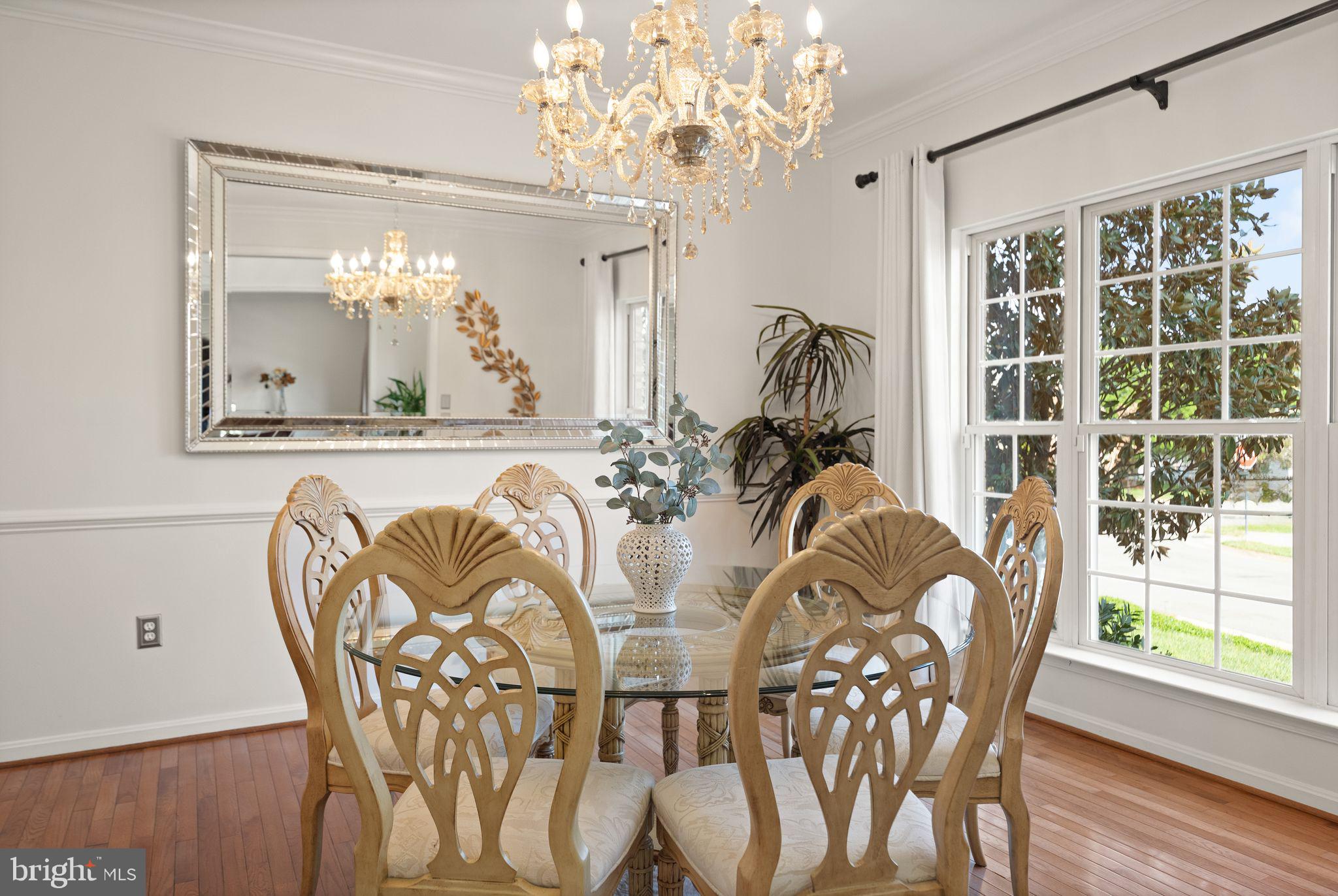 43179 Parkers Ridge Drive Leesburg, VA 20176 - Photo 17 of 108 a view of a dining room with furniture a chandelier and wooden floor