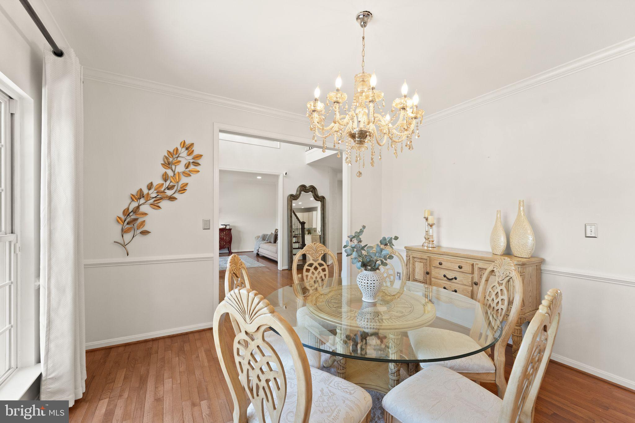 43179 Parkers Ridge Drive Leesburg, VA 20176 - Photo 19 of 108 a view of a dining room with furniture wooden floor and chandelier