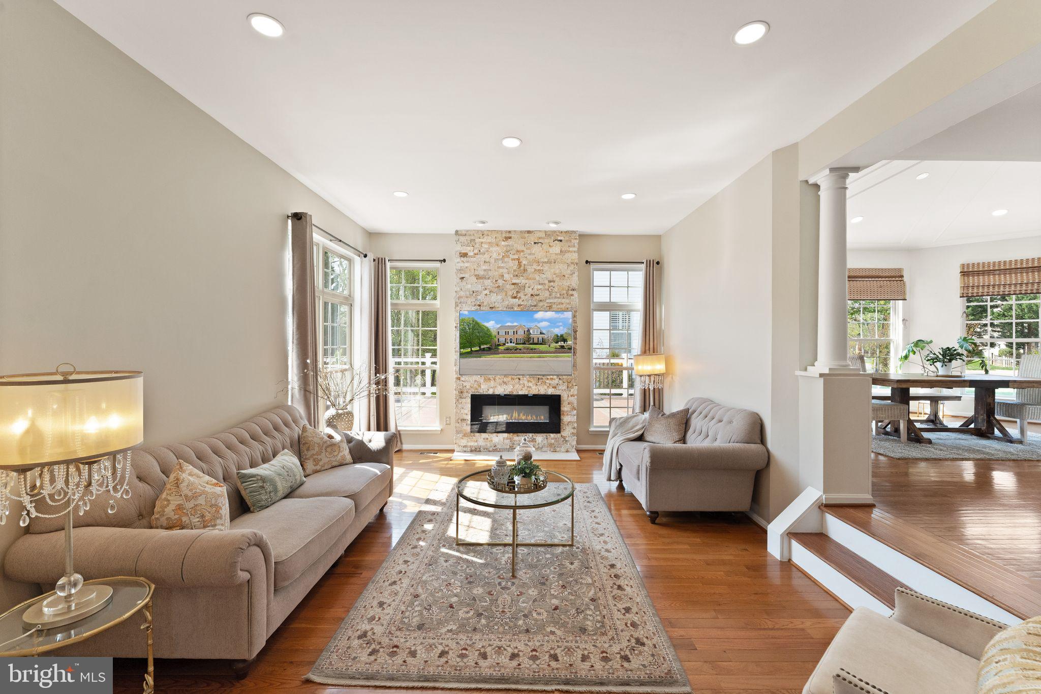 43179 Parkers Ridge Drive Leesburg, VA 20176 - Photo 23 of 108 a living room with furniture a fireplace and a table