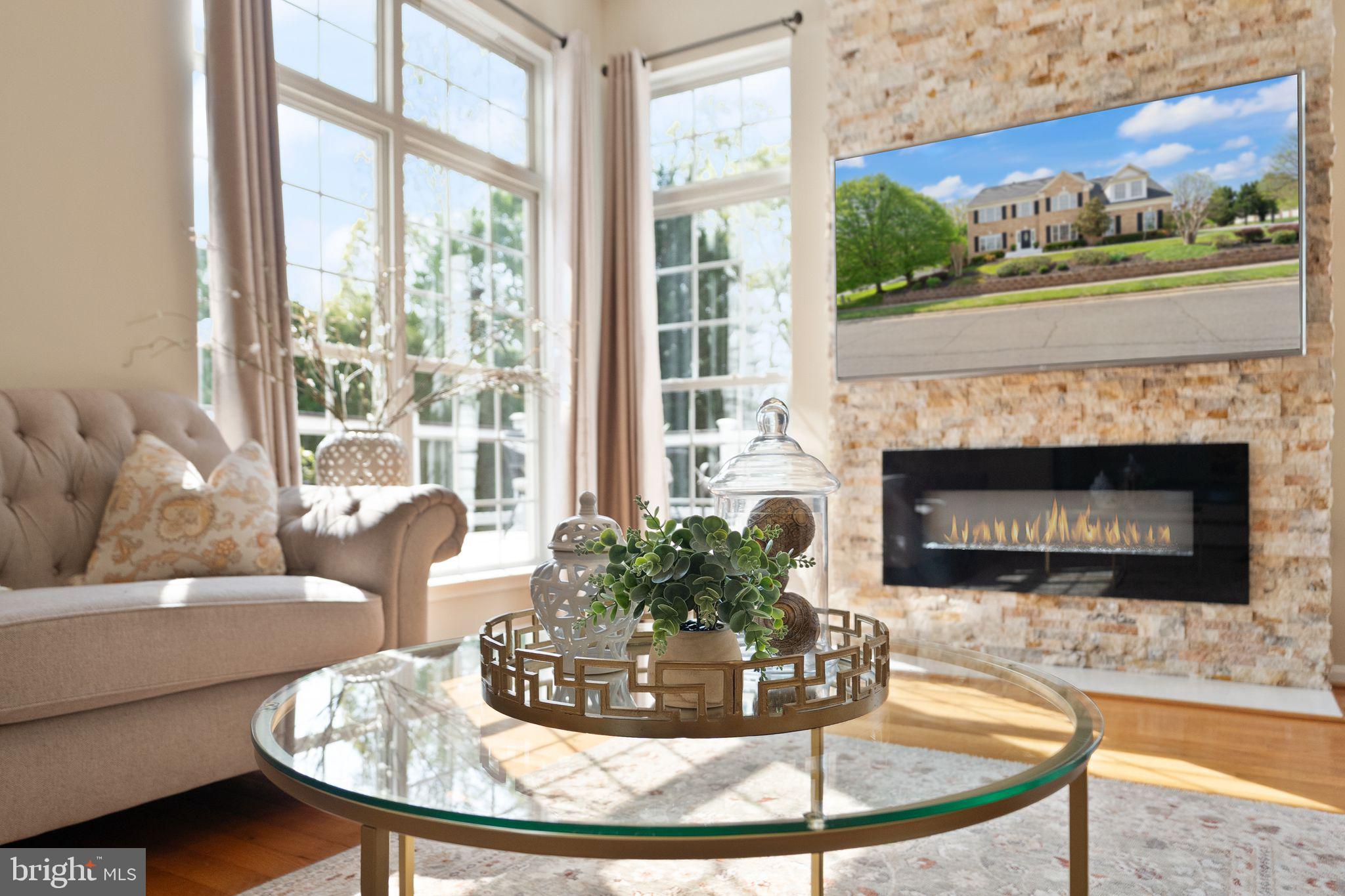 43179 Parkers Ridge Drive Leesburg, VA 20176 - Photo 27 of 108 a living room with furniture a fireplace and a large window