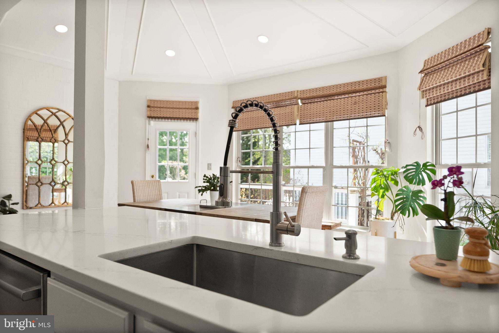 43179 Parkers Ridge Drive Leesburg, VA 20176 - Photo 36 of 108 a kitchen with a sink a faucet a potted plant and a granite counter top