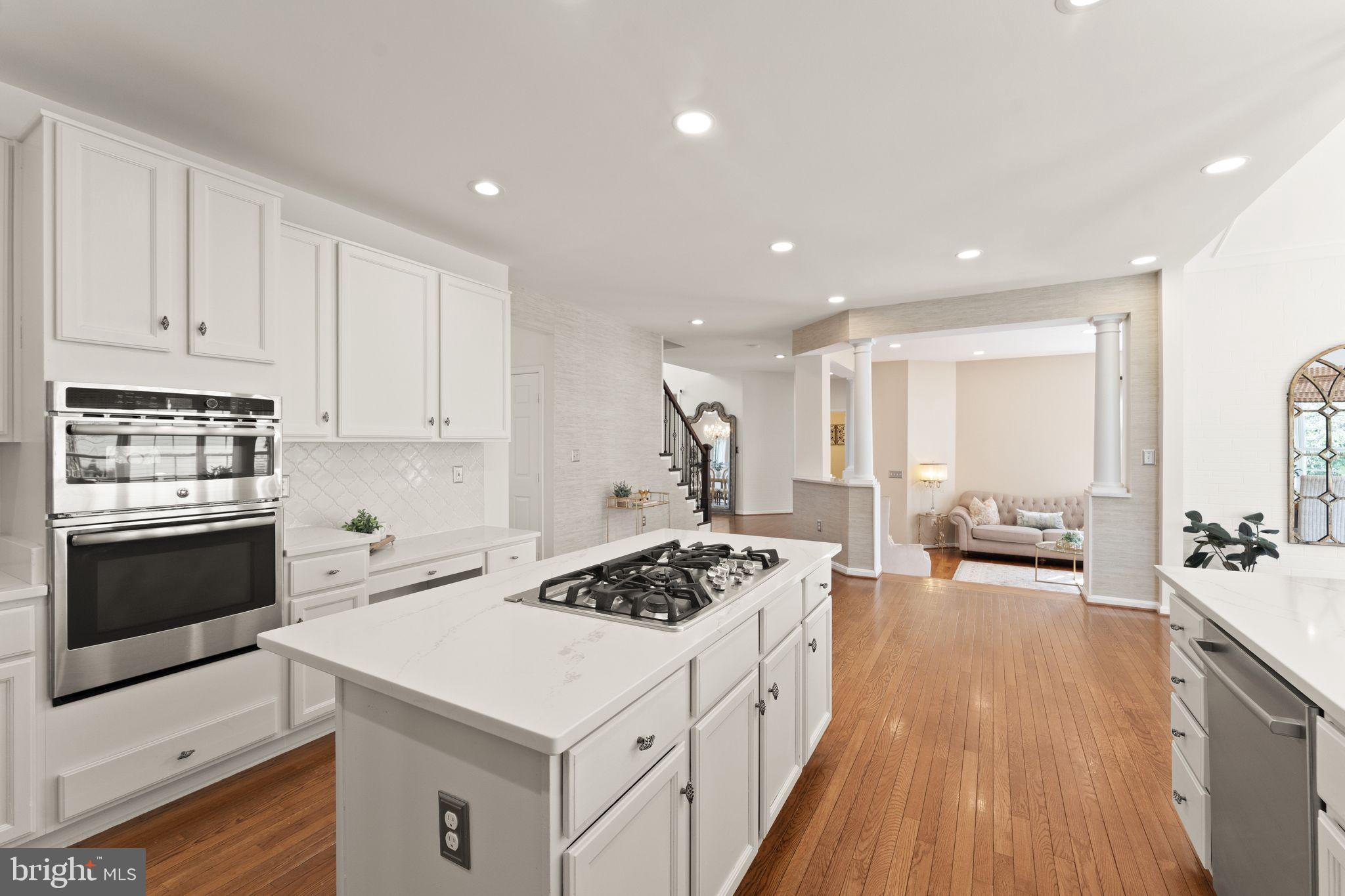 43179 Parkers Ridge Drive Leesburg, VA 20176 - Photo 37 of 108 a kitchen with a stove a sink a refrigerator and cabinets