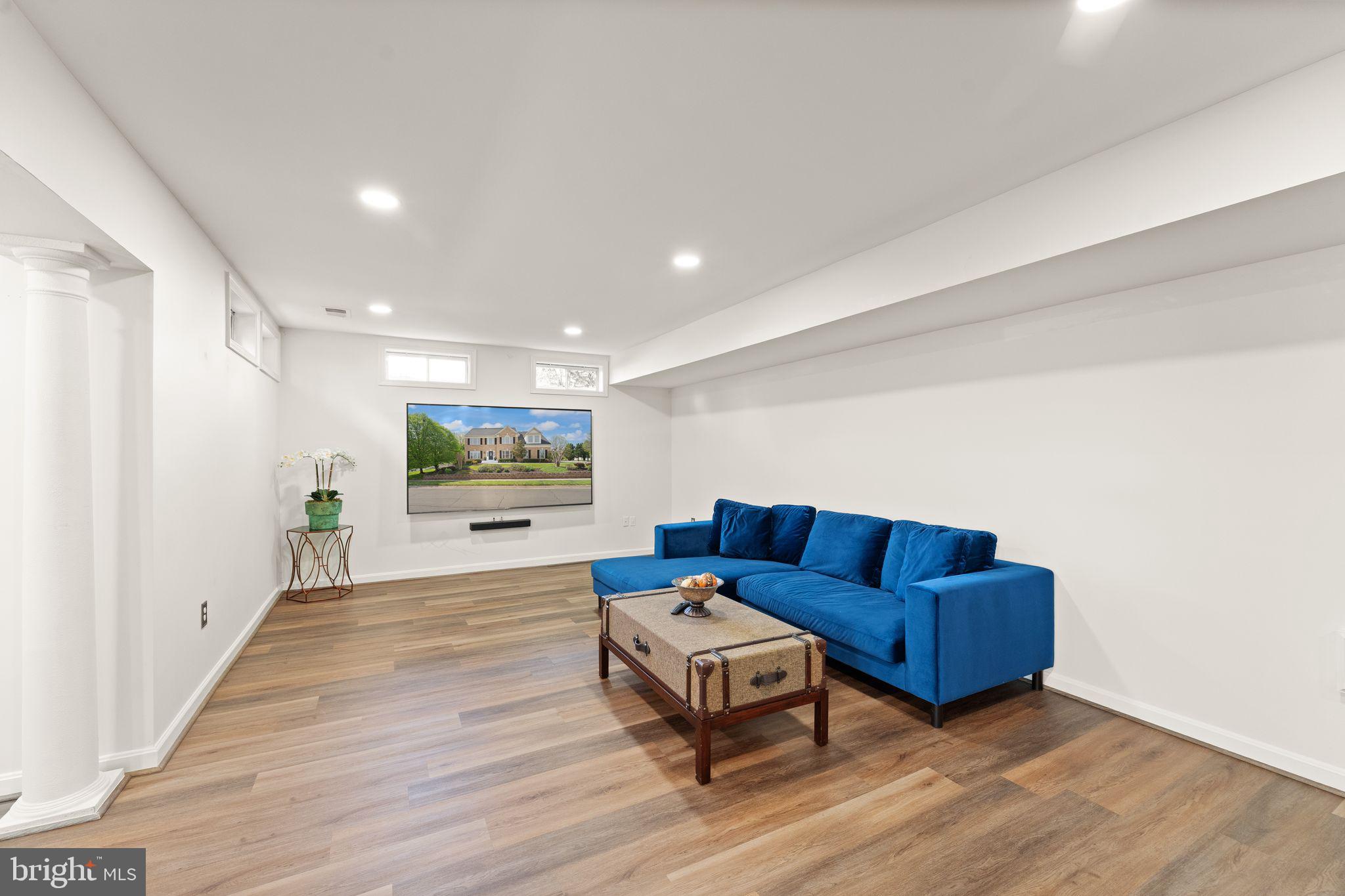 43179 Parkers Ridge Drive Leesburg, VA 20176 - Photo 70 of 108 a living room with furniture and a wooden floor