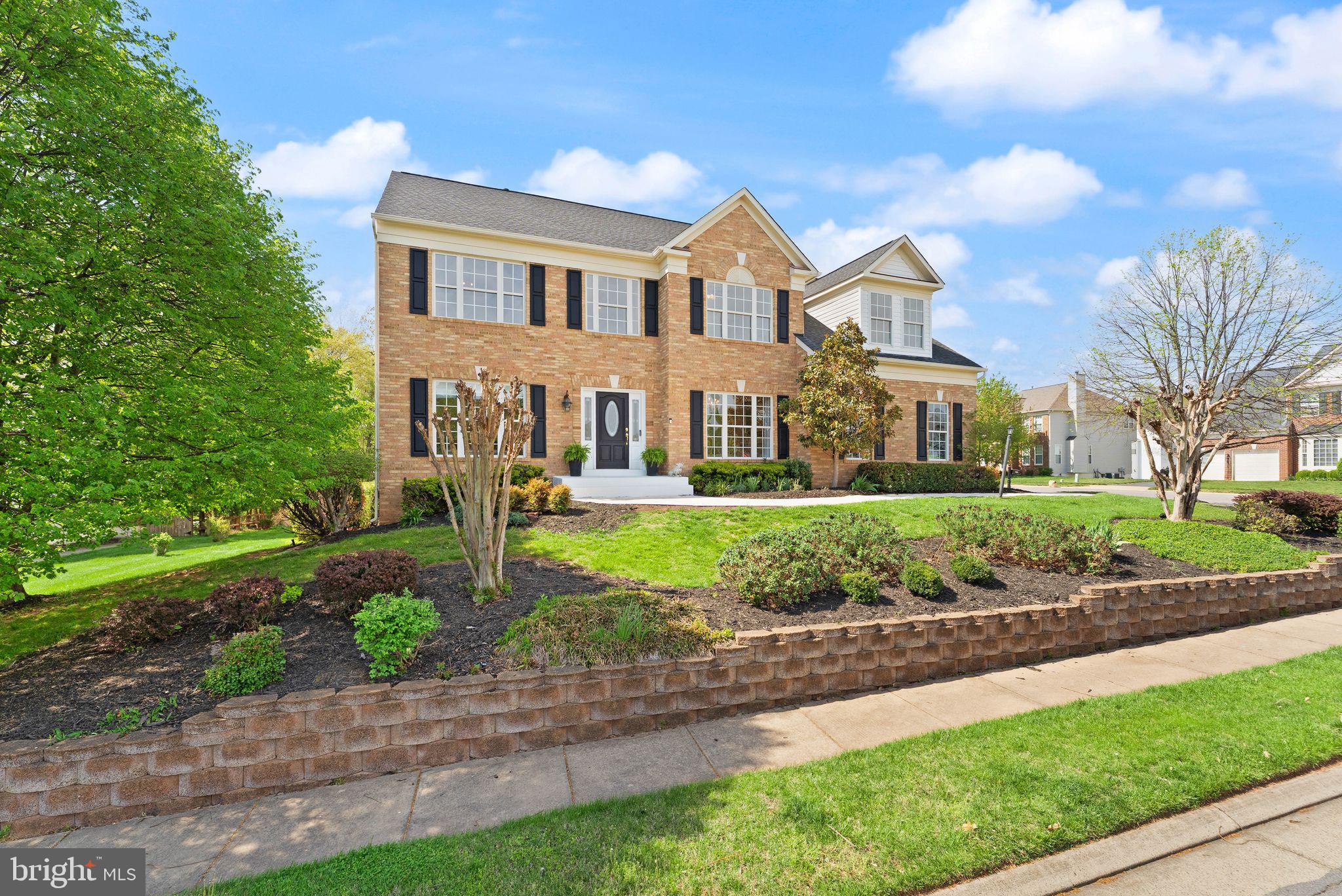 43179 Parkers Ridge Drive Leesburg, VA 20176 - Photo 7 of 108 a front view of a house with a yard and potted plants
