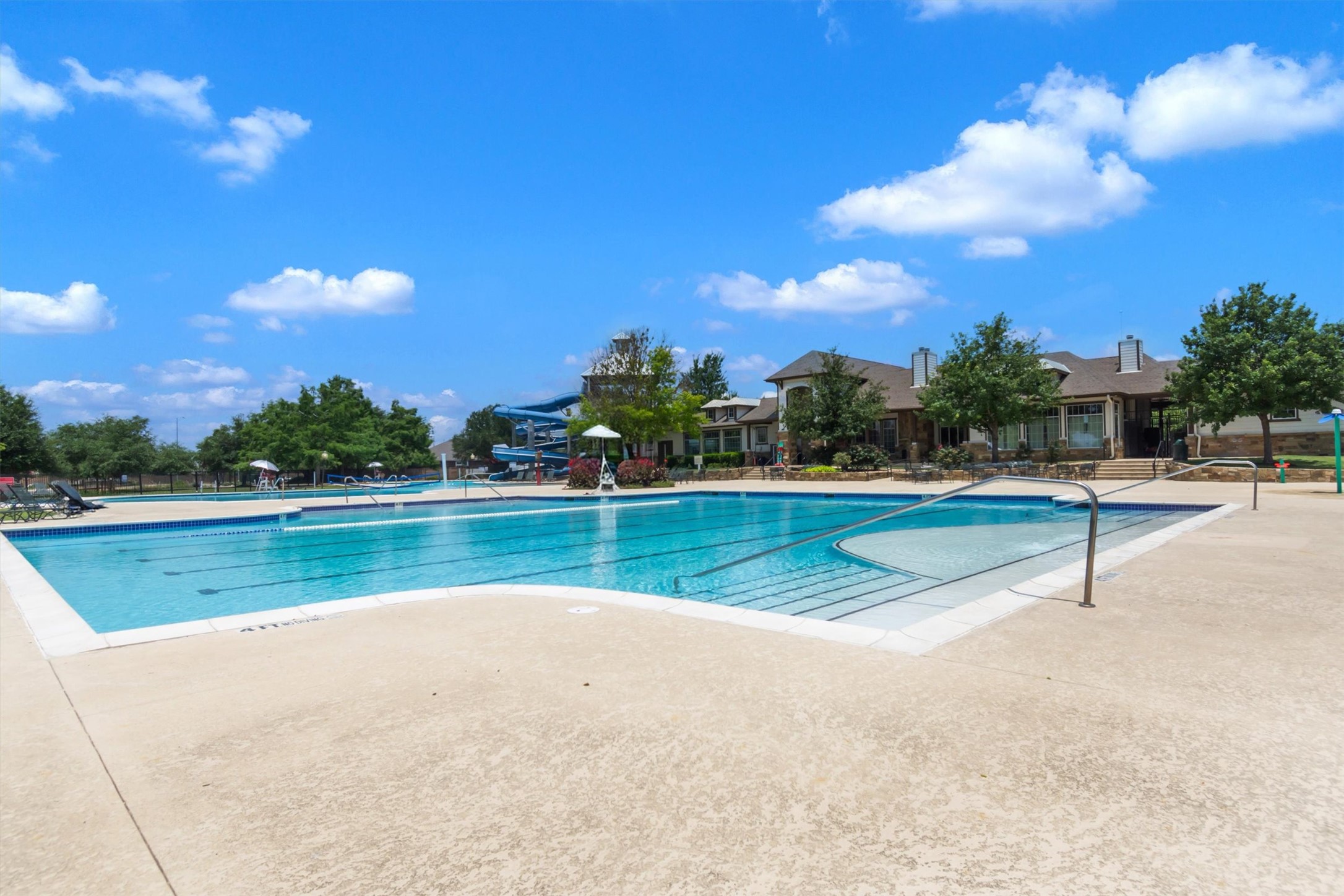 11701 Jackson Falls Way Manor, TX 78653 - Photo 33 of 40 An inviting community pool awaits, featuring ample swimming lanes and a thrilling water slide for all ages.
