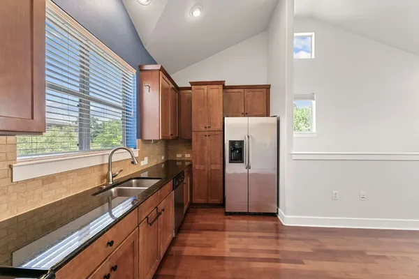 a kitchen with stainless steel appliances a sink stove and refrigerator