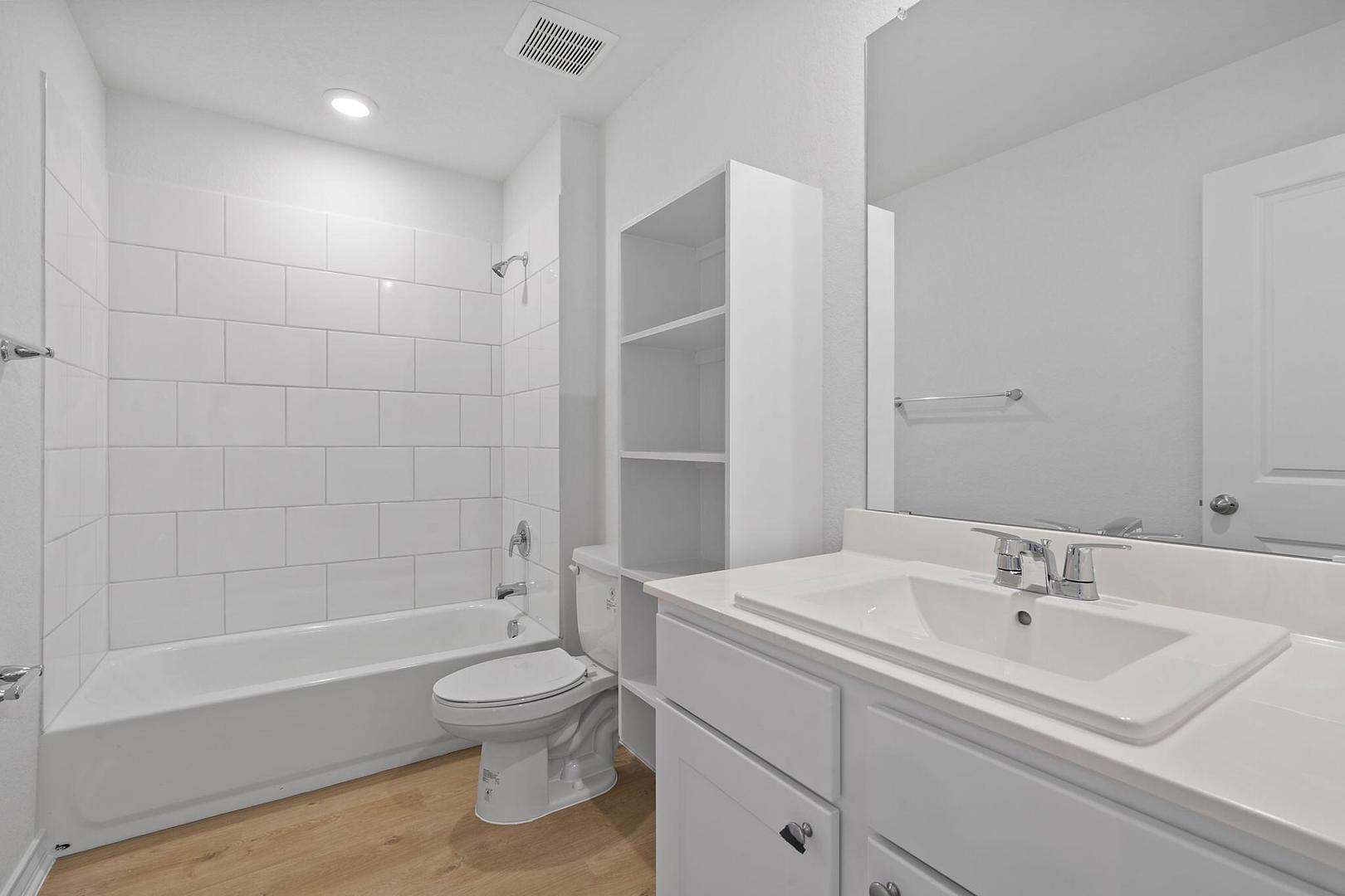 109 Hatari Trail Jarrell, TX 76537 - Photo 17 of 31 A well-appointed bathroom offers a clean vanity with a sink and ample storage.