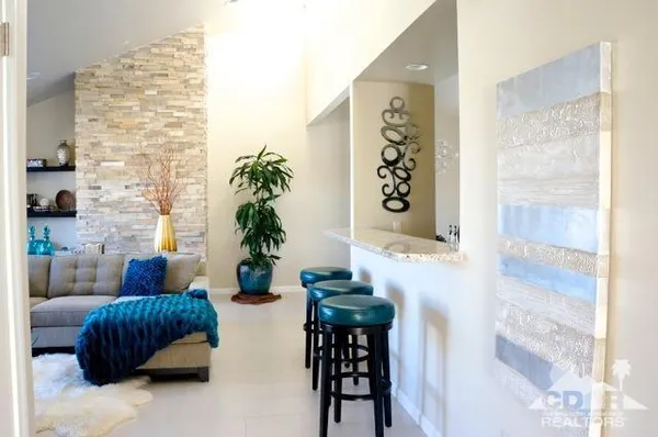 a living room with furniture and a potted plant