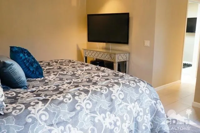 a bedroom with a bed and a flat screen tv