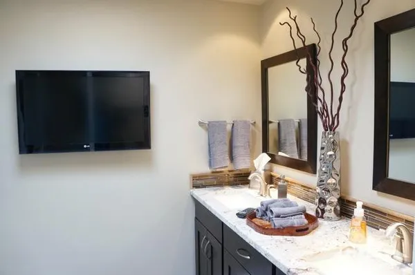 a bathroom with a double vanity sink and a mirror