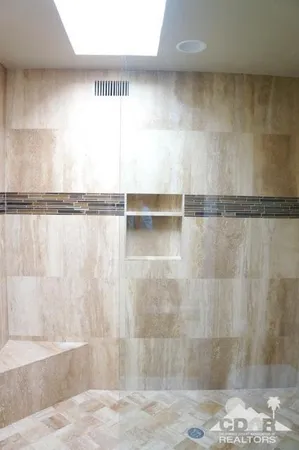 a view of a hallway with a room and front door