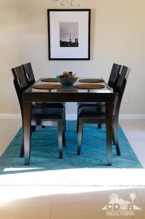 a living room with furniture and a piano