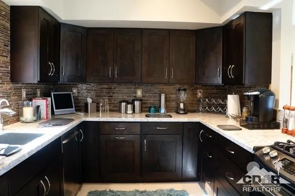a kitchen with a sink a stove a microwave and cabinets