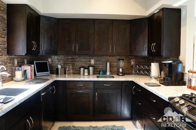 a kitchen with a sink a stove a microwave and cabinets