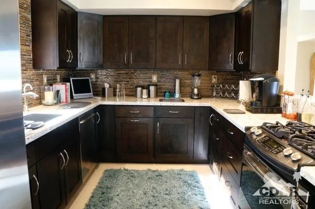 a kitchen with a sink stove top oven and cabinets