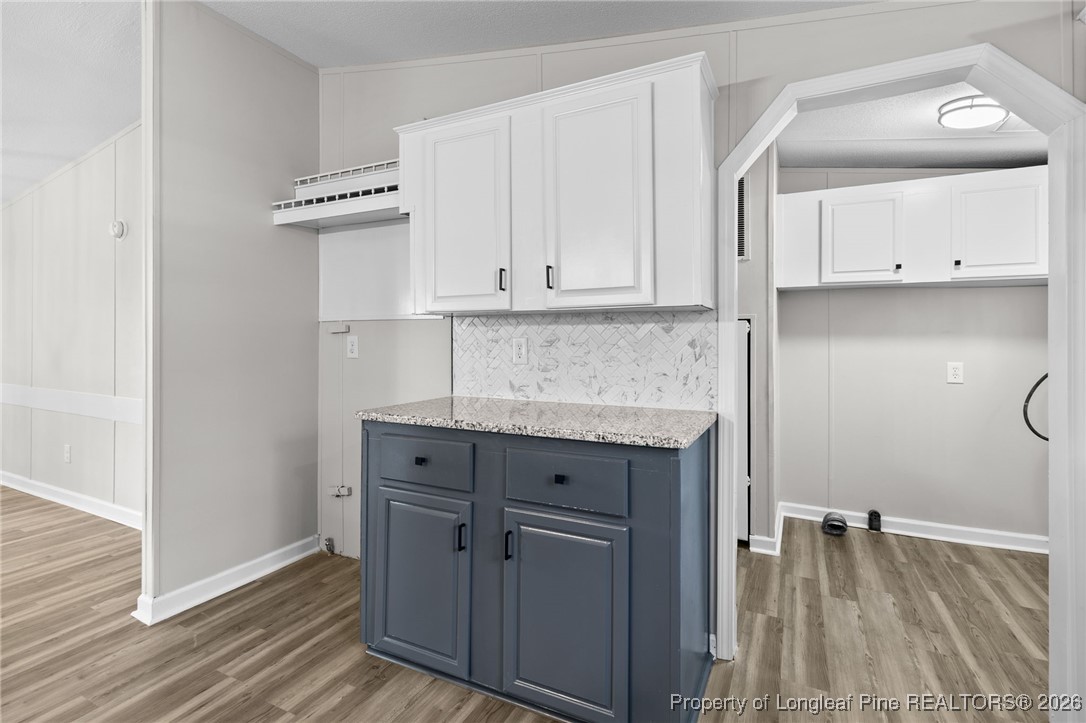 1750 John Russell Road Raeford, NC 28376 - Photo 14 of 39 a kitchen with granite countertop a sink cabinets and wooden floor