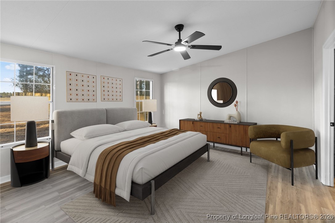 1750 John Russell Road Raeford, NC 28376 - Photo 18 of 39 a bedroom with bed and a chandelier