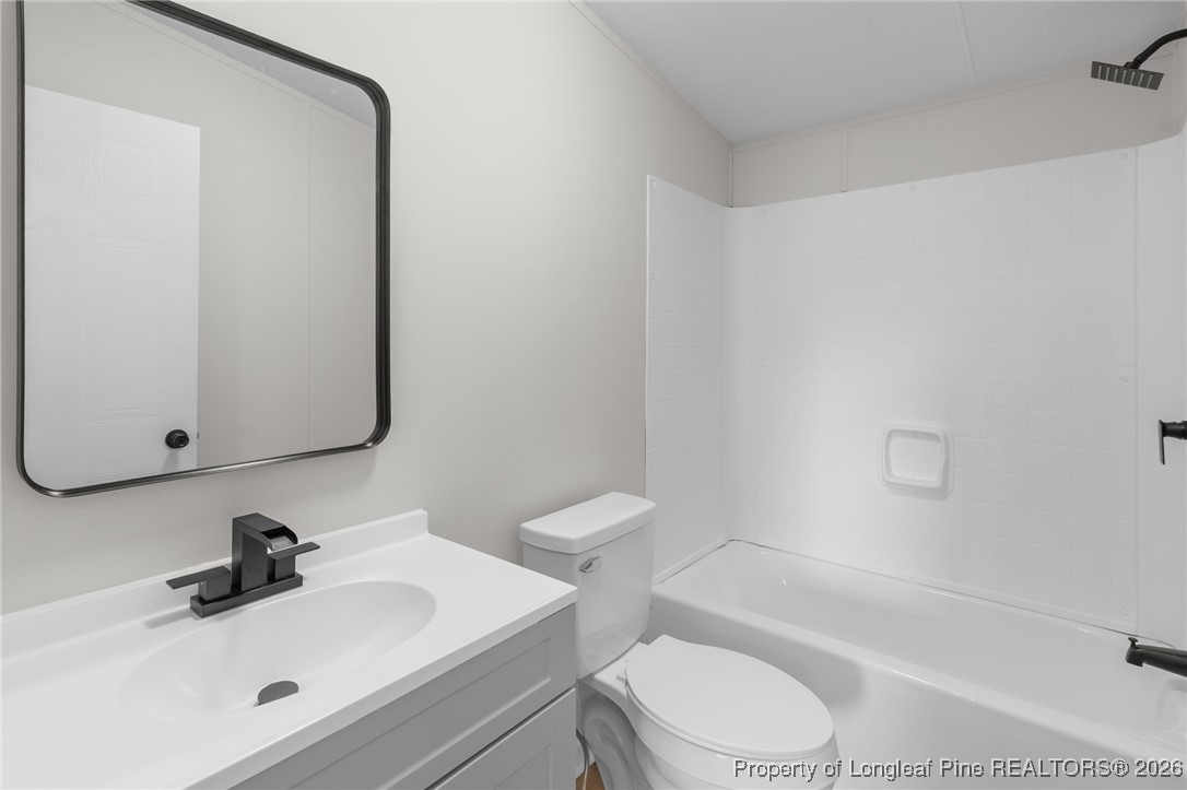 1750 John Russell Road Raeford, NC 28376 - Photo 28 of 39 a bathroom with a sink toilet and shower