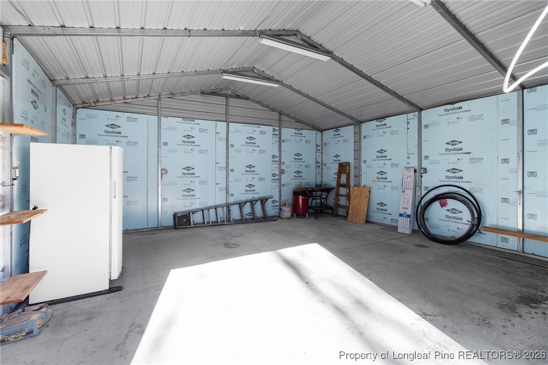 1750 John Russell Road Raeford, NC 28376 - Photo 34 of 39 a view of a storage & utility room with a fridge