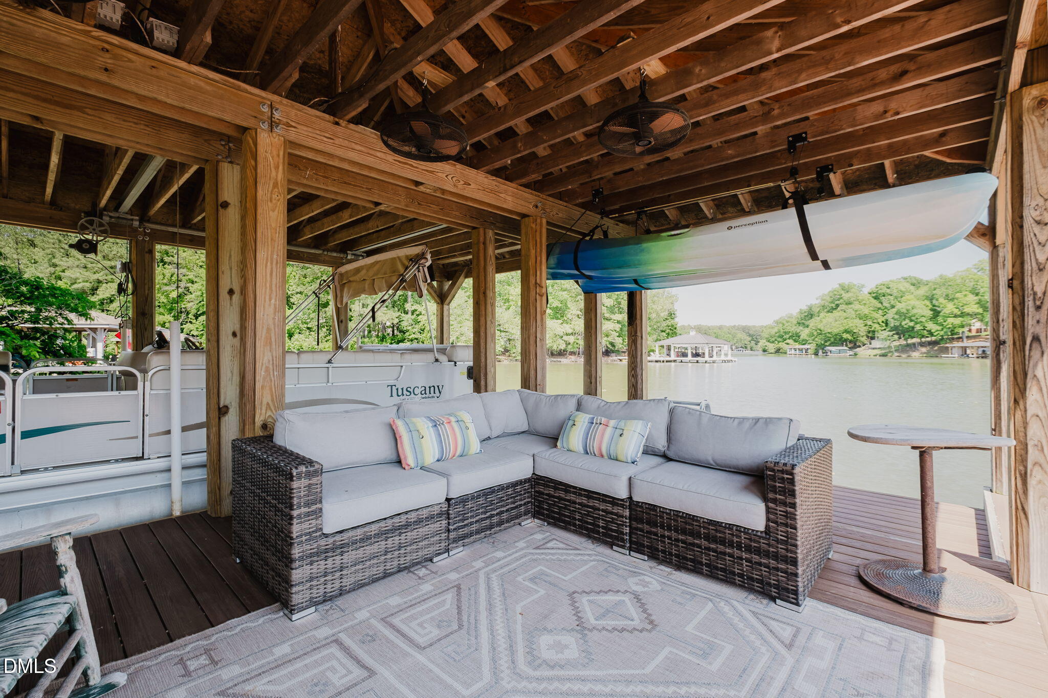 370 Robinson Ferry Road Macon, NC 27551 - Photo 15 of 85 a outdoor living space with furniture and a black umbrella