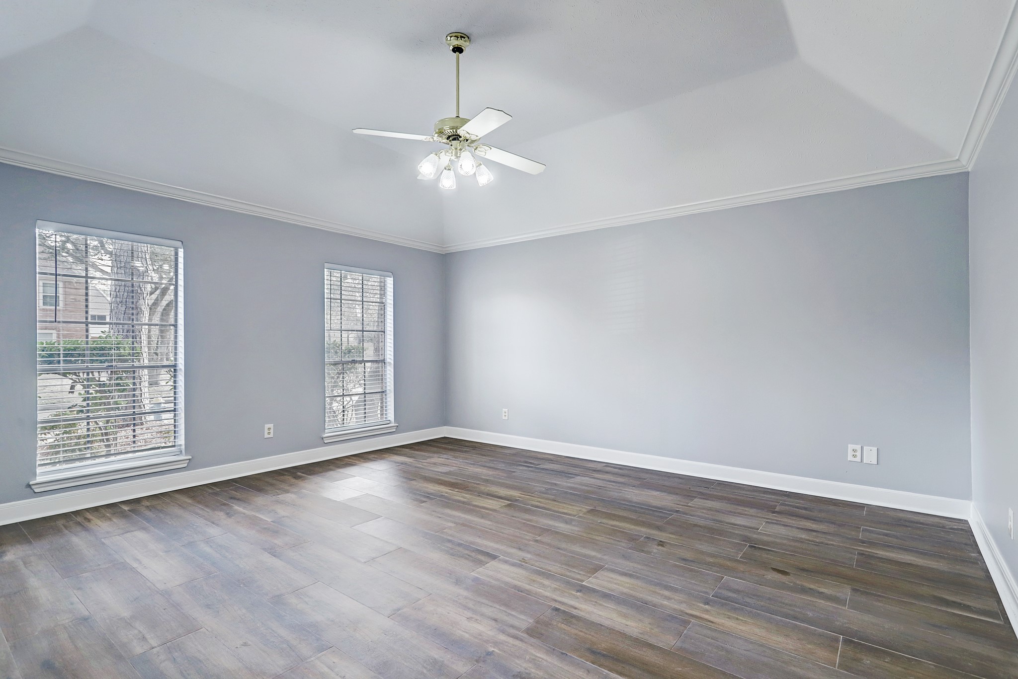 7403 Manor Bridge Court Houston, TX 77095 - Photo 5 of 11 an empty room with wooden floor chandelier fan and windows