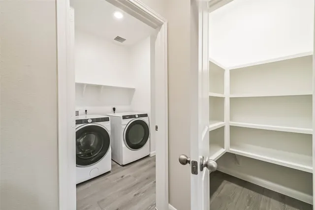 a utility room with sink dryer and washer