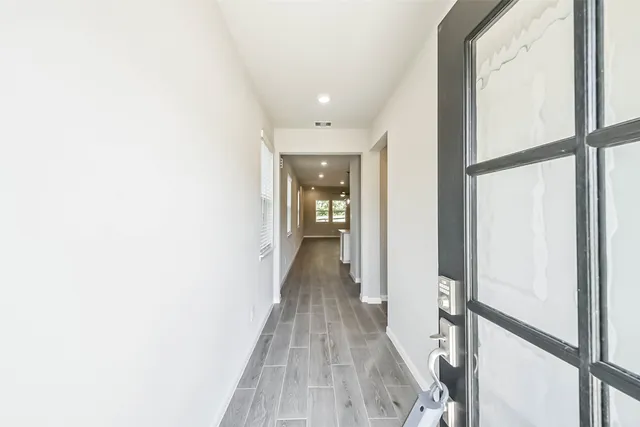 a view of hallway with wooden floor