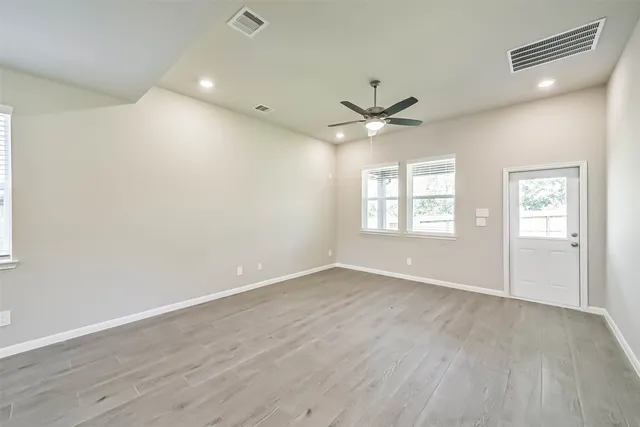 wooden floor in an empty room with a window
