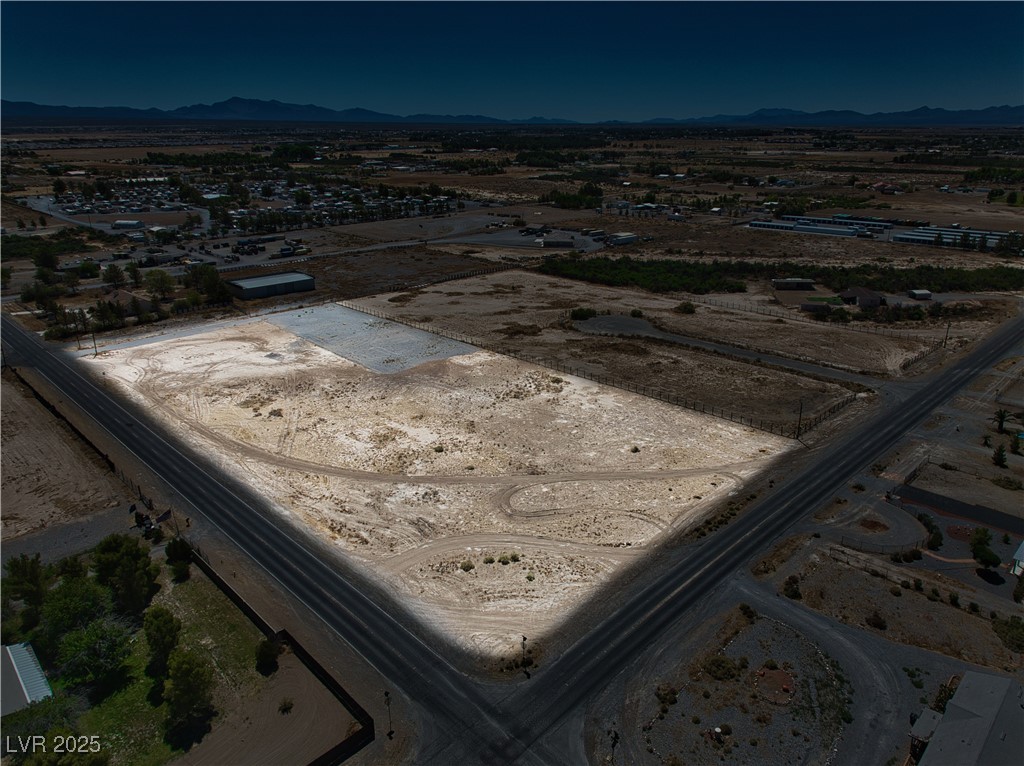 2161 East Manse Road Pahrump, NV 89048 - Photo 2 of 18 Aerial view of property's location featuring a mountainous background and rural landscape