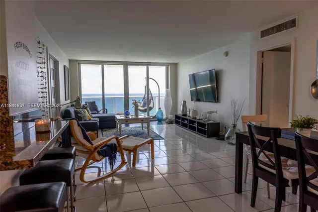 a view of a dining room with furniture and a large window