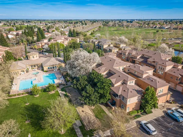 an aerial view of residential building and lake