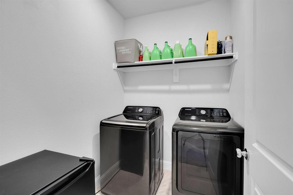 1498 Weston Road Dallas, TX 75234 - Photo 21 of 24 Dedicated laundry area featuring a white wall shelf, textured white walls, and bright white trim