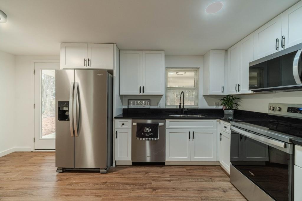 3617 Bob White Lane Southwest Loganville, GA 30052 - Photo 11 of 48 a kitchen with a refrigerator stove and sink