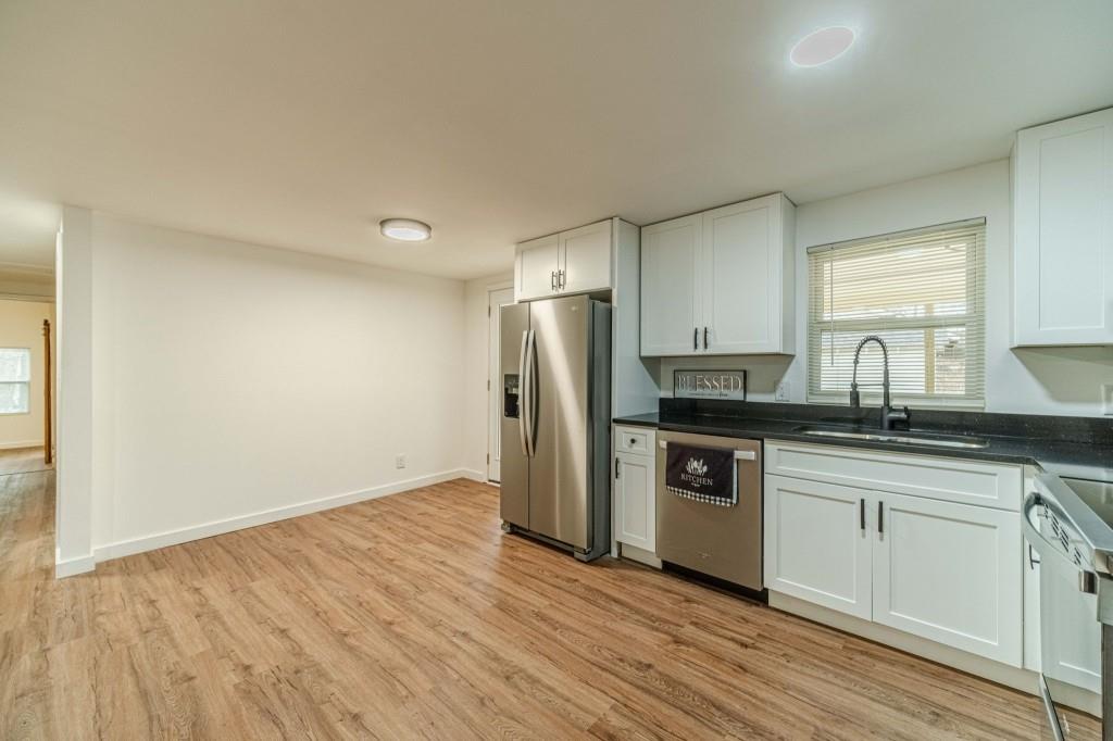 3617 Bob White Lane Southwest Loganville, GA 30052 - Photo 12 of 48 a kitchen with stainless steel appliances granite countertop a sink and cabinets