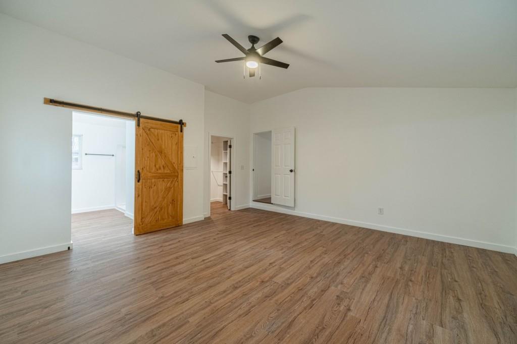 3617 Bob White Lane Southwest Loganville, GA 30052 - Photo 16 of 48 an empty room with wooden floor and a ceiling fan