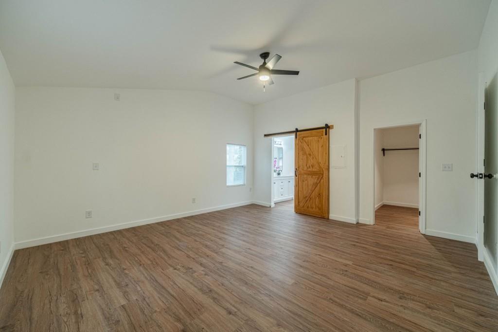 3617 Bob White Lane Southwest Loganville, GA 30052 - Photo 18 of 48 an empty room with wooden floor and ceiling fan