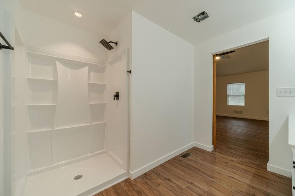 3617 Bob White Lane Southwest Loganville, GA 30052 - Photo 23 of 48 a bathroom with a glass shower door and a bathtub