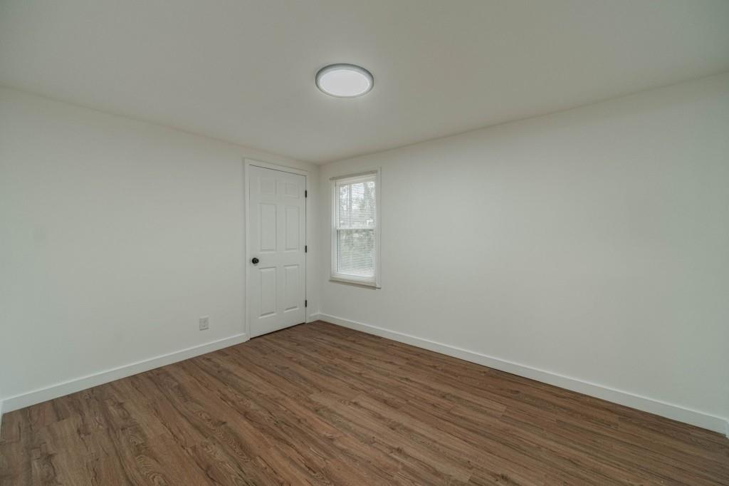 3617 Bob White Lane Southwest Loganville, GA 30052 - Photo 28 of 48 a view of an empty room with wooden floor and a window