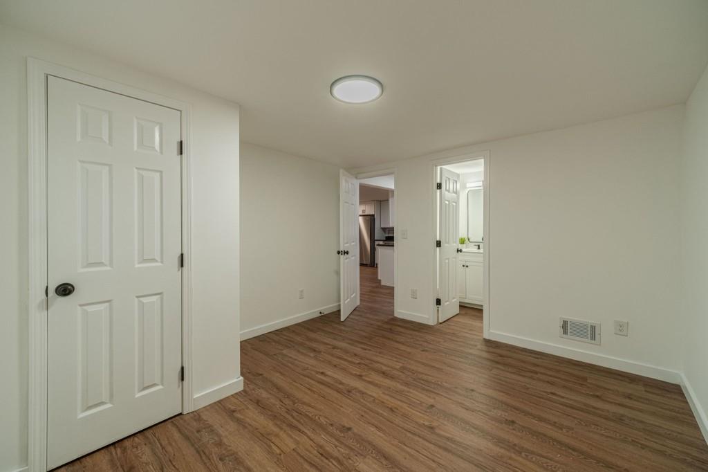 3617 Bob White Lane Southwest Loganville, GA 30052 - Photo 30 of 48 a view of an empty room with wooden floor and a bathroom
