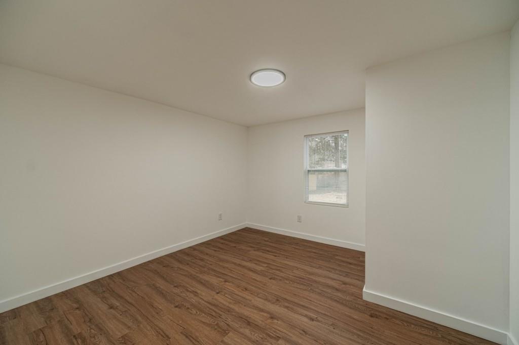 3617 Bob White Lane Southwest Loganville, GA 30052 - Photo 31 of 48 an empty room with wooden floor and windows