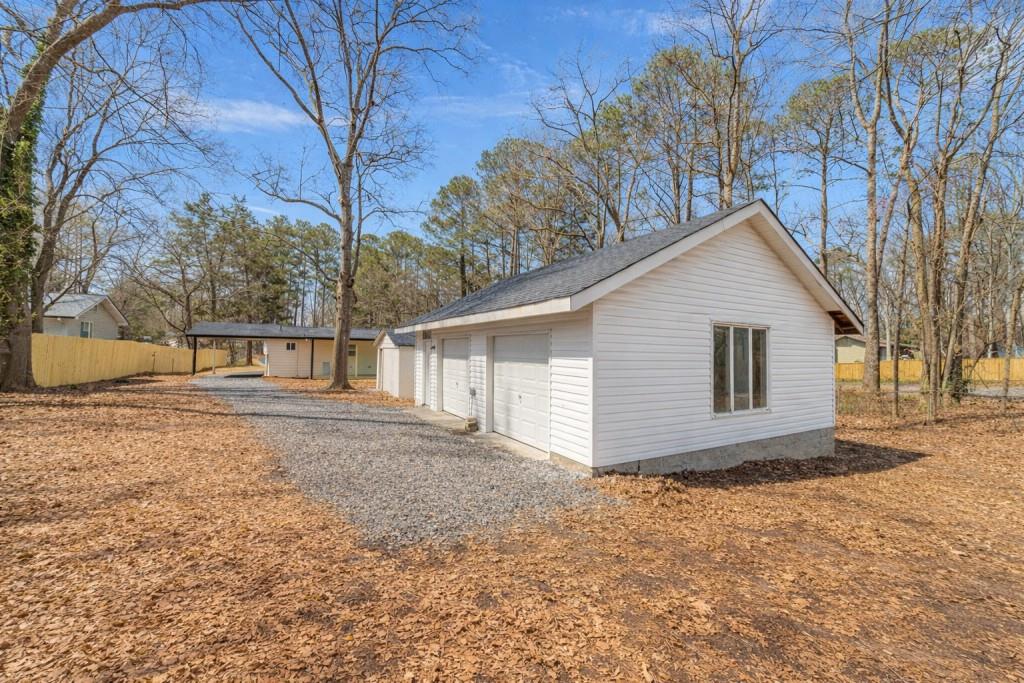 3617 Bob White Lane Southwest Loganville, GA 30052 - Photo 36 of 48 a view of a house with a yard covered in snow