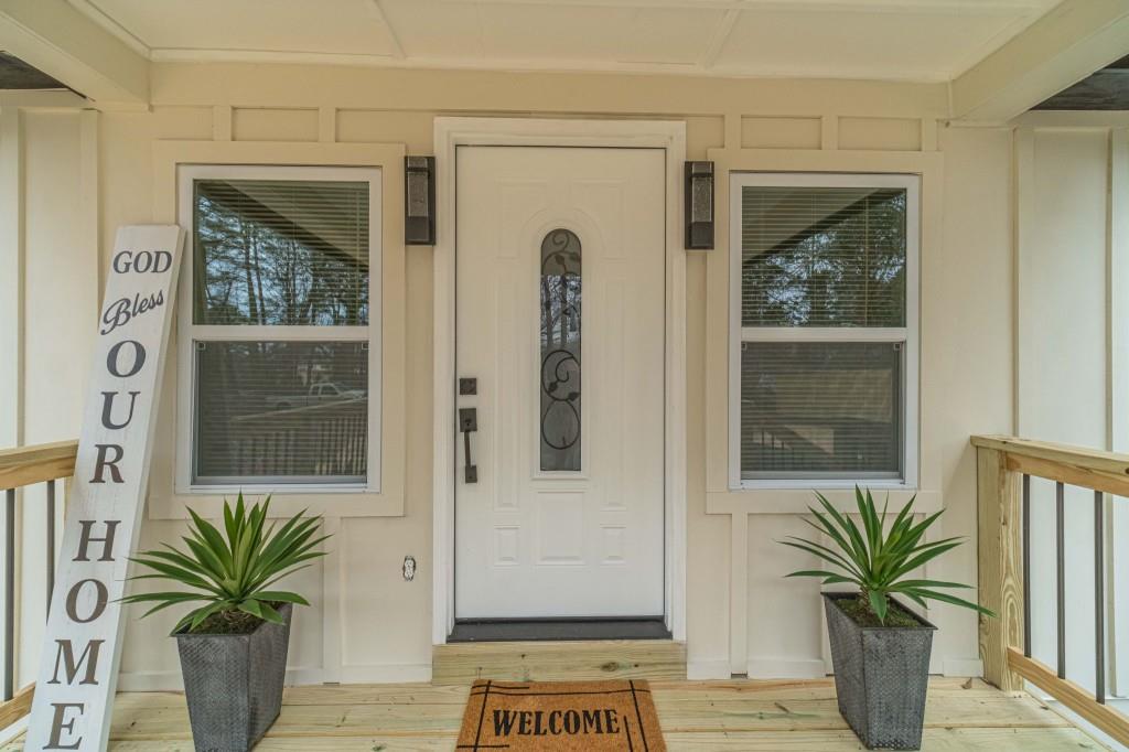 3617 Bob White Lane Southwest Loganville, GA 30052 - Photo 4 of 48 a potted plant sitting in front of a door